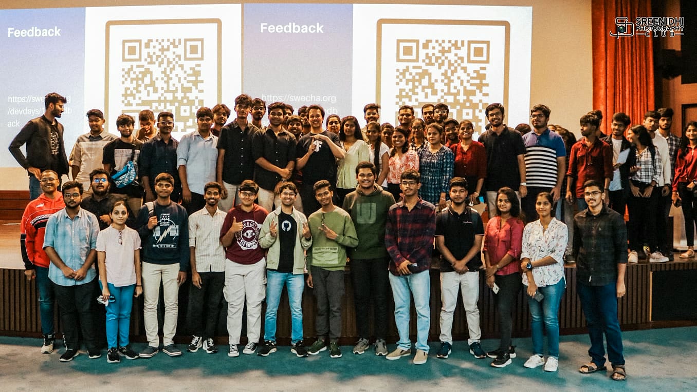 A university developer community gathered onstage after a meetup